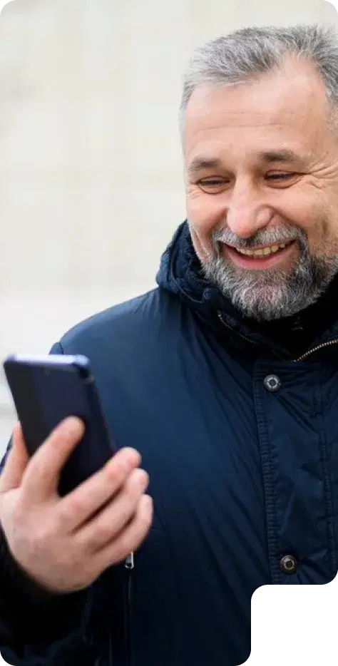 Smiling man looking at his phone